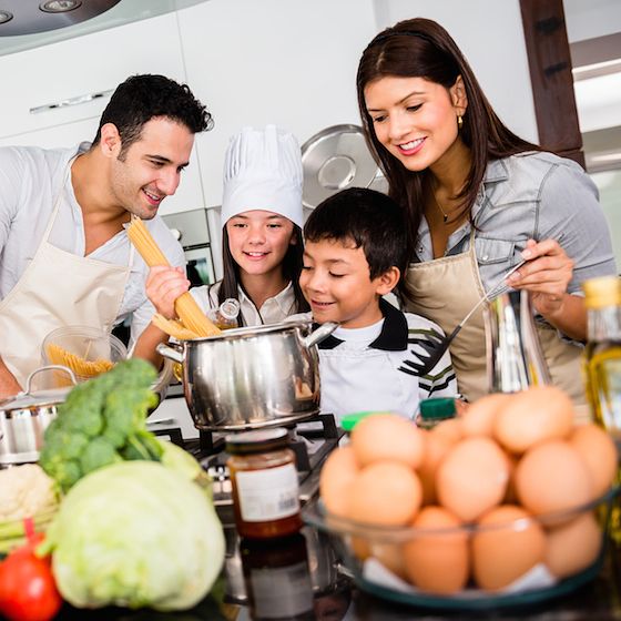 Image of a family cooking together. 