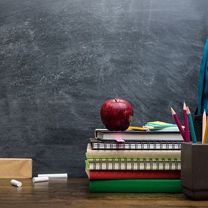 Apple, books, chalk board