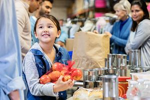 Girl in food bank with apples