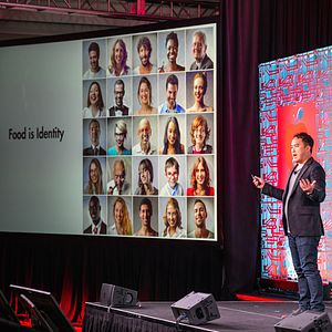 Mike Lee of The Future Market delivers a presentation on the main plenary stage of Partnership for a Healthier America's 2018 Innovating a Healthier Future Summit. Mike's slide says 'Food is Identity.' 