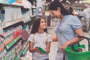 Image of a daughter and mother shopping in a grocery store.