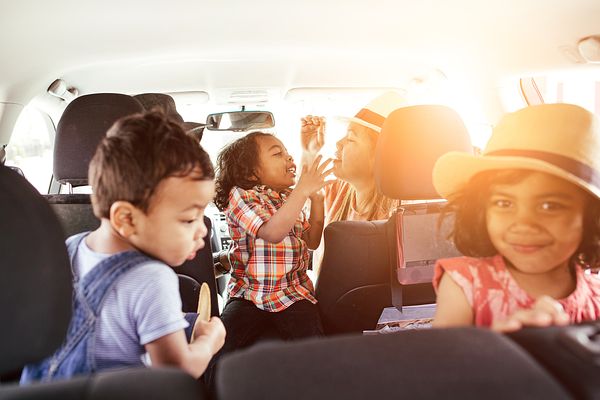 Image of a family in a car on the way to a vacation. 