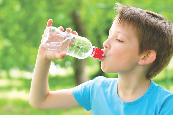 Boy drinking from water bottle