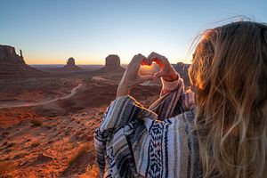 Young woman in the American desert making heart shape frame with hands loving road trip adventure stock photo
Arizona, Monument Valley, USA, Utah, Desert