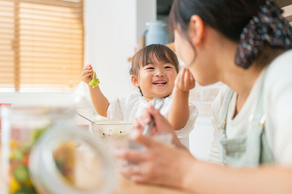 A woman and her daughter enjoy a healthy meal