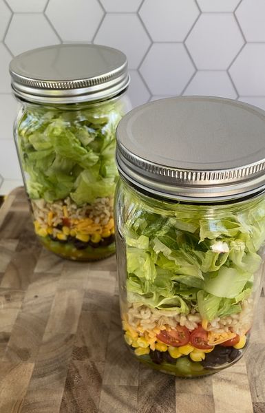 Salad materials layered in a jar