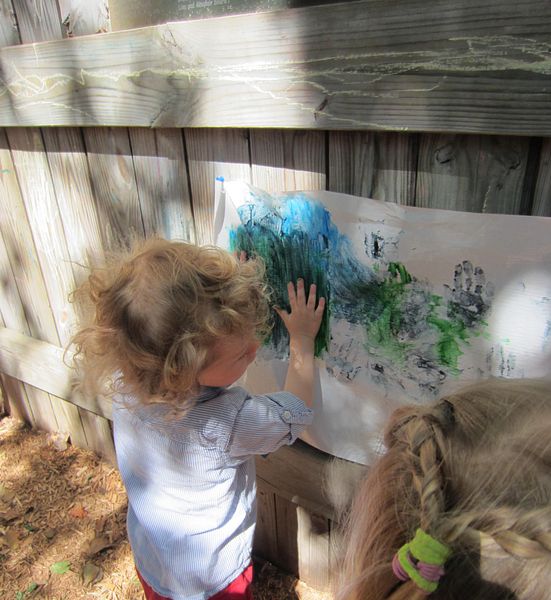 Image of a young child, Max, playing in a yard at an out-of-school time center.