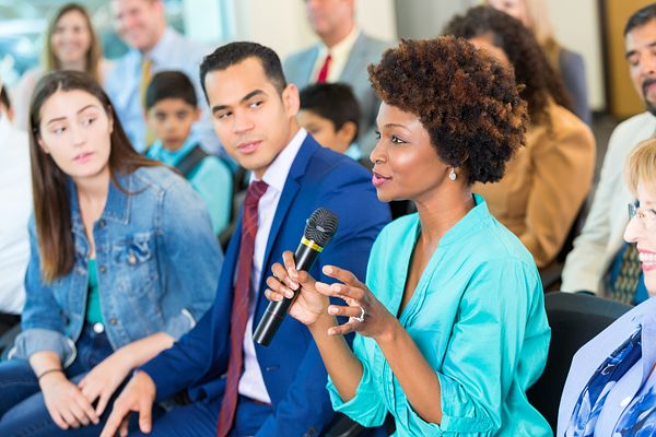 A woman speaks during a meeting to discuss local issues