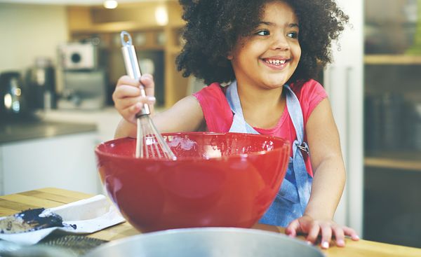 Image of a girl stirring food. 