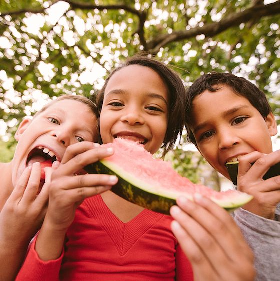 Image of children eating watermelon. 
