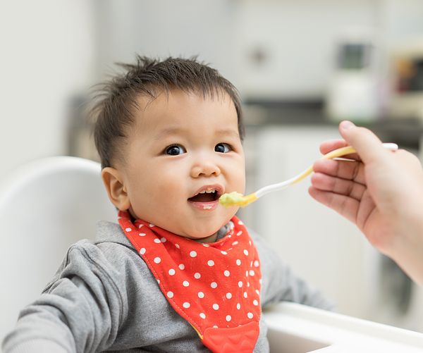 Baby eating veggie-forward product