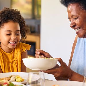 Woman and young girl sharing a meal