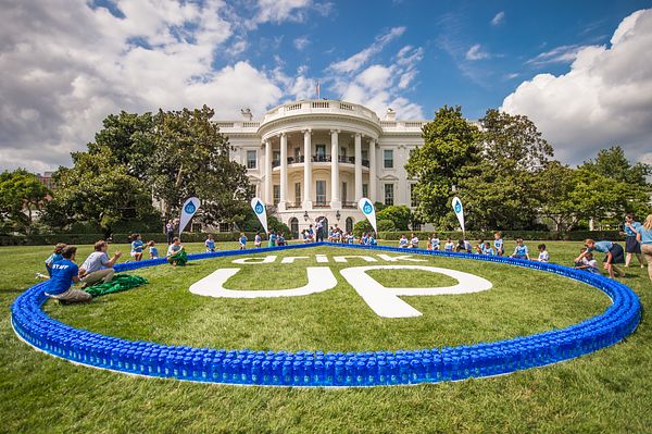 Image of Drink Up celebrating new partners at the White House in 2014. Nalgene water bottles with Partnership for a Healthier America's Drink Up initiative logo displayed on the White House lawn during the campaign's anniversary celebration. 