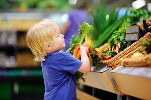 Young boy picking out carrots