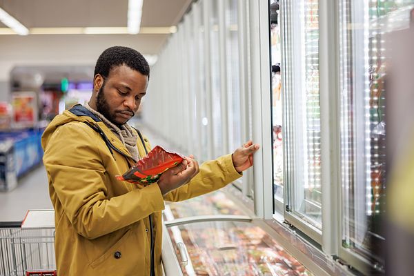 PERSON LOOKING AT PRODUCE