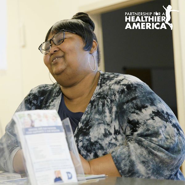 Charmaine from Good Food for All in New Orleans, LA smiling at her place of employment