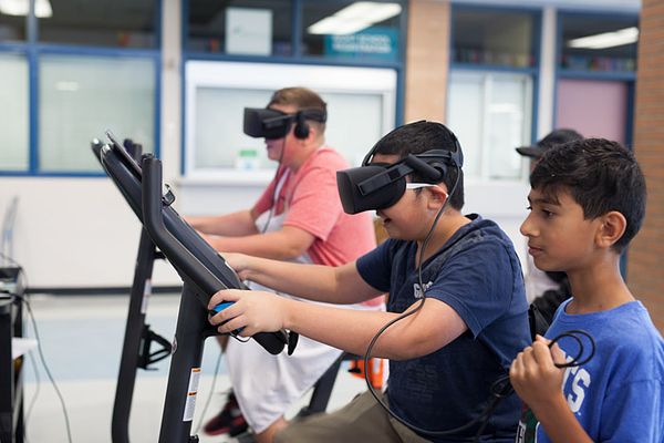 Image of three children playing a Blue Goji virtual reality game. 