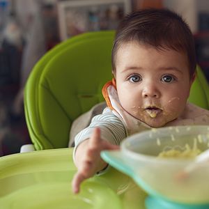 baby eating green vegetables