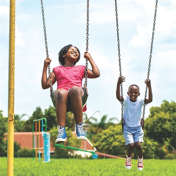 Image of two children on a swing. 