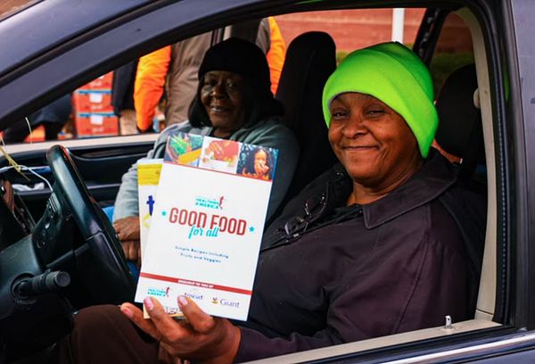 Women holding a PHA Good Food for All box