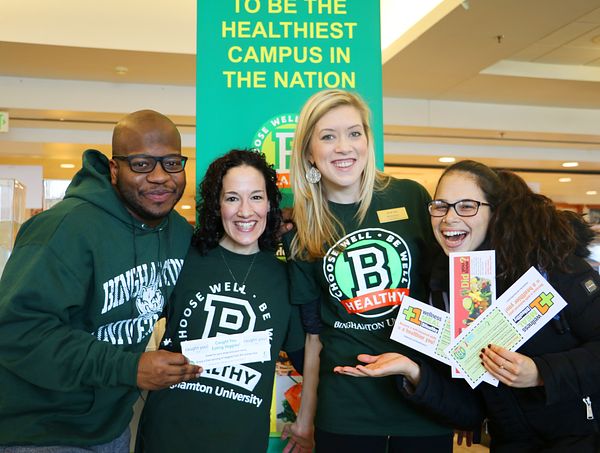 Photo of Binghamton University students holding pamphlets at a campus health fair. The school is a PHA partner participating in the Healthier Campus Initiative. 
